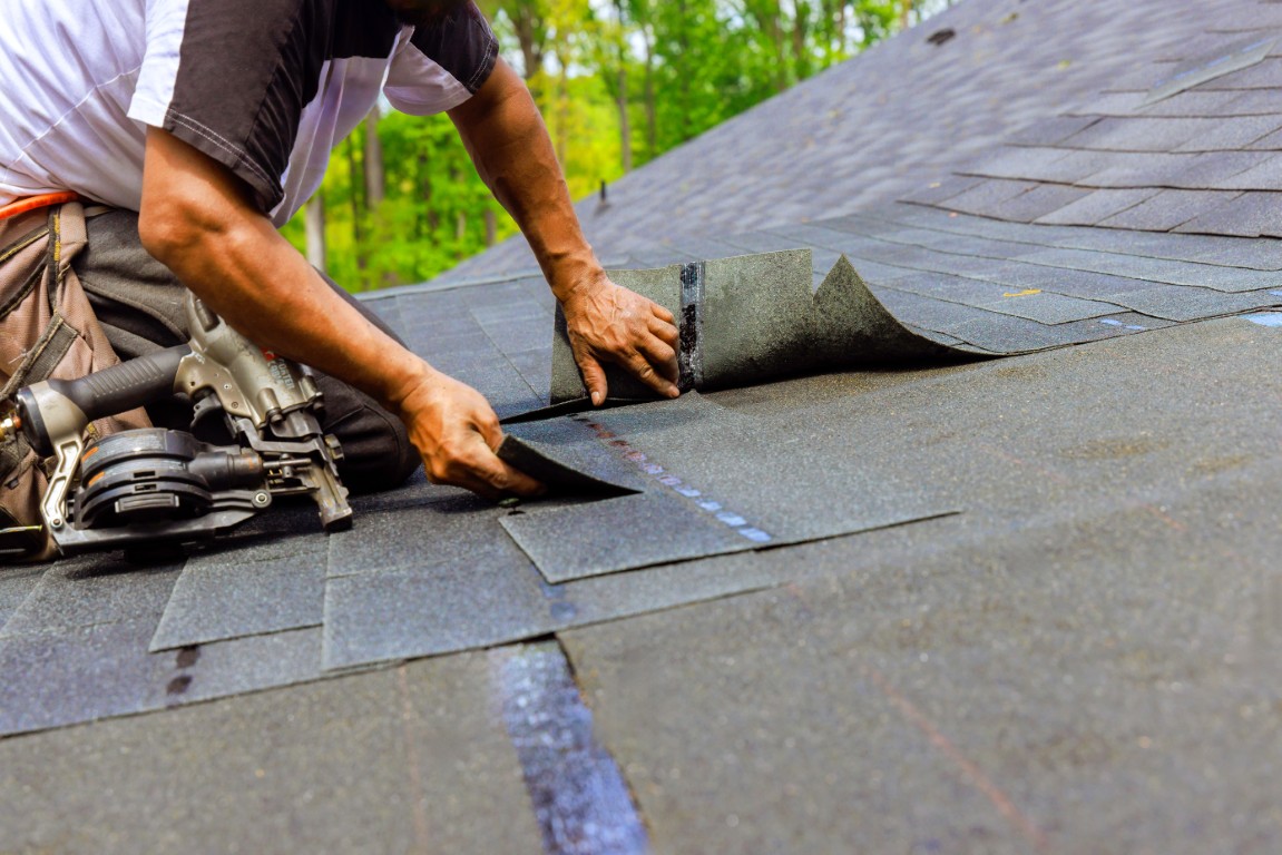 Construction,Worker,Using,Pneumatic,Nail,Gun,To,Install,New,Bitumen